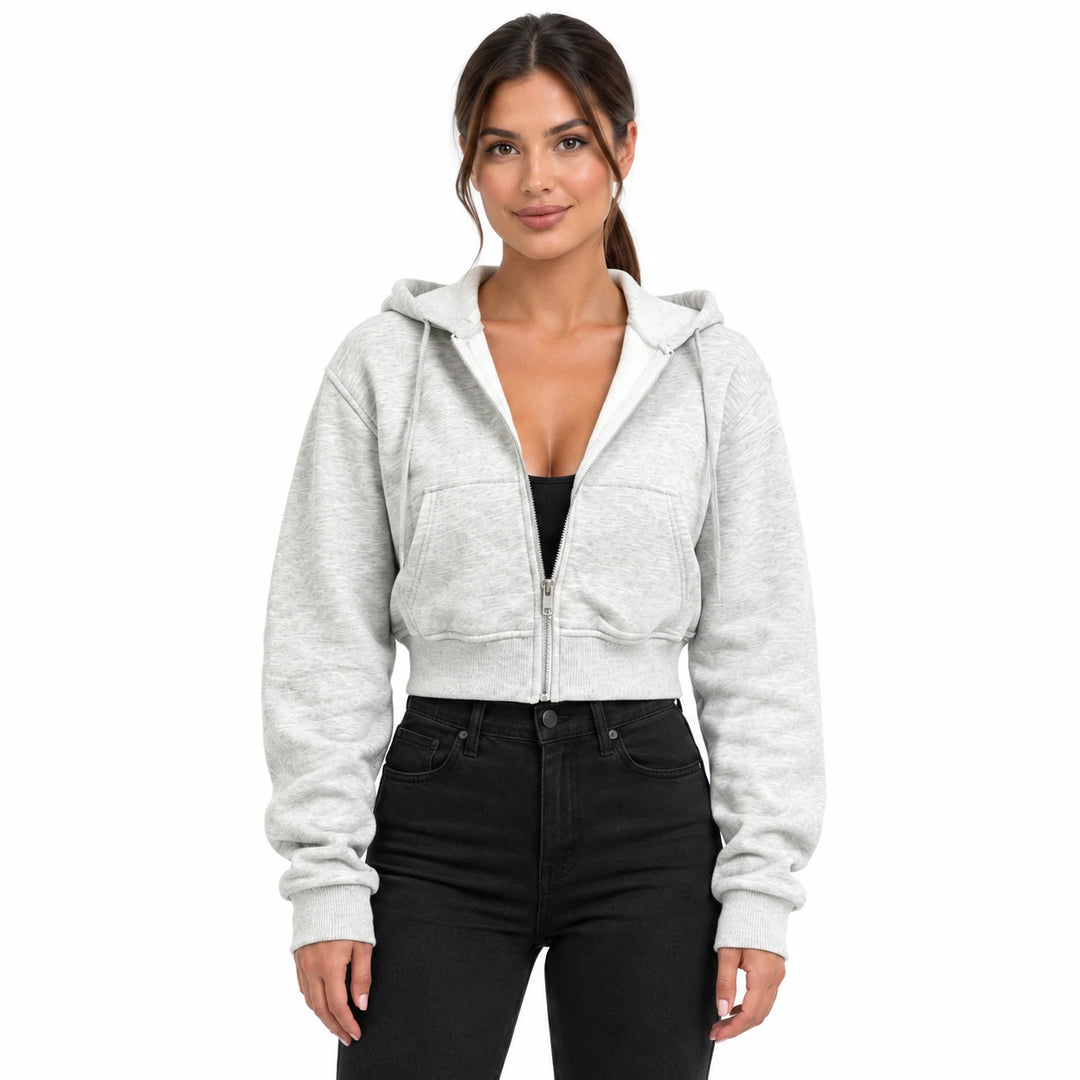 Heather gray hooded sweatshirt on a model in an upper-body studio view, showing front pockets, long sleeves and a ribbed hem.