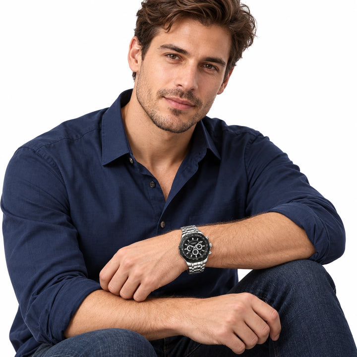 Male model wearing a CURREN 8084 black-dial quartz watch with a silver stainless steel bracelet.