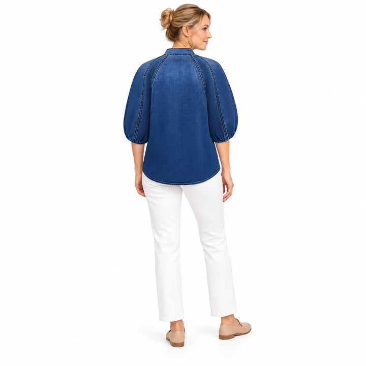 Denim puff sleeve top in Dark Blue on an adult model, shown from the back with raglan seams and its curved hem against white.