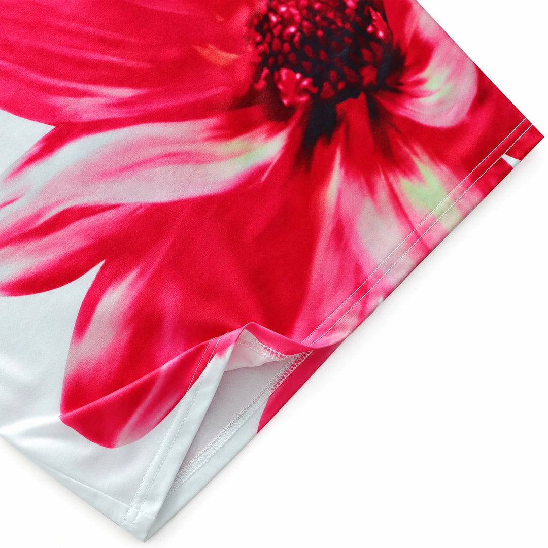 Close-up of the rose red floral print and hem on the strapless dress.