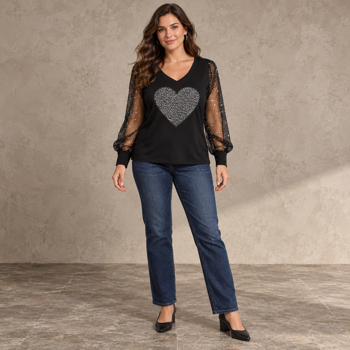 Black V-neck top with a solid silver heart and sheer dotted sleeves, shown full length on a model