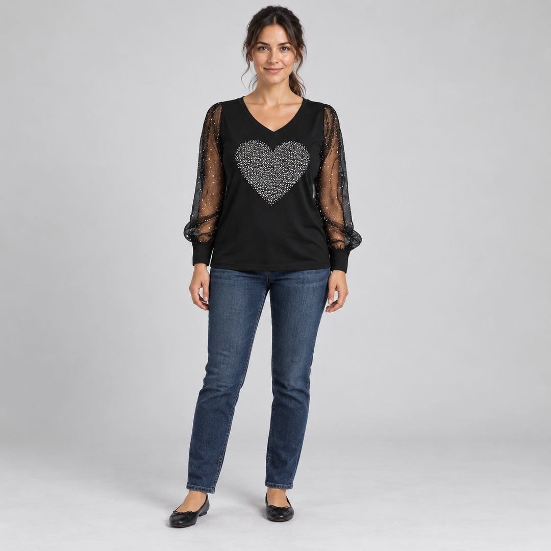 Front view of the black V-neck top with a solid silver heart and sheer sleeves on a full-length model