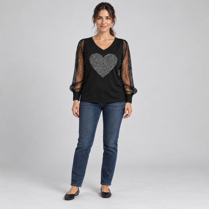 Front view of the black V-neck top with a solid silver heart and sheer sleeves on a full-length model