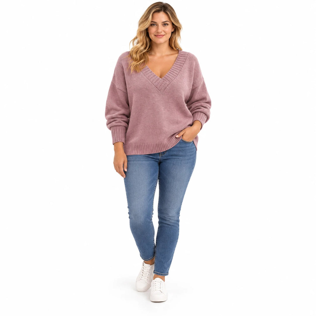 Adult woman wearing the Bean Pink V-neck knit pullover, in a full-length studio pose against a plain white studio background.