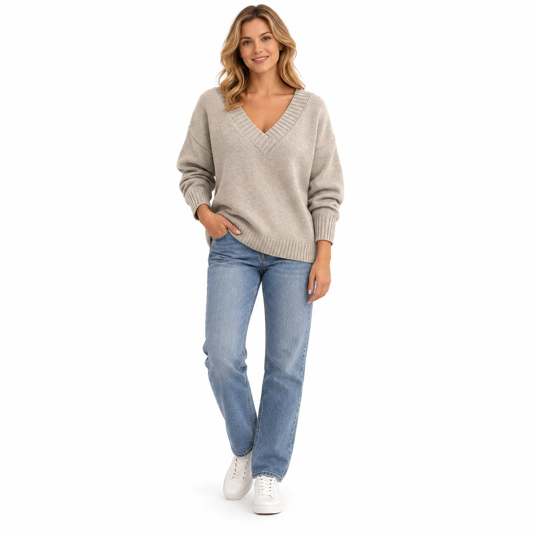 Adult woman modelling the Apricot V-neck knit pullover, in a full-length studio pose against a plain white studio background.