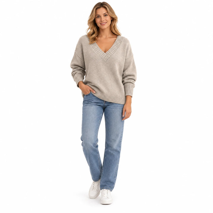 Adult woman modelling the Apricot V-neck knit pullover, in a full-length studio pose against a plain white studio background.