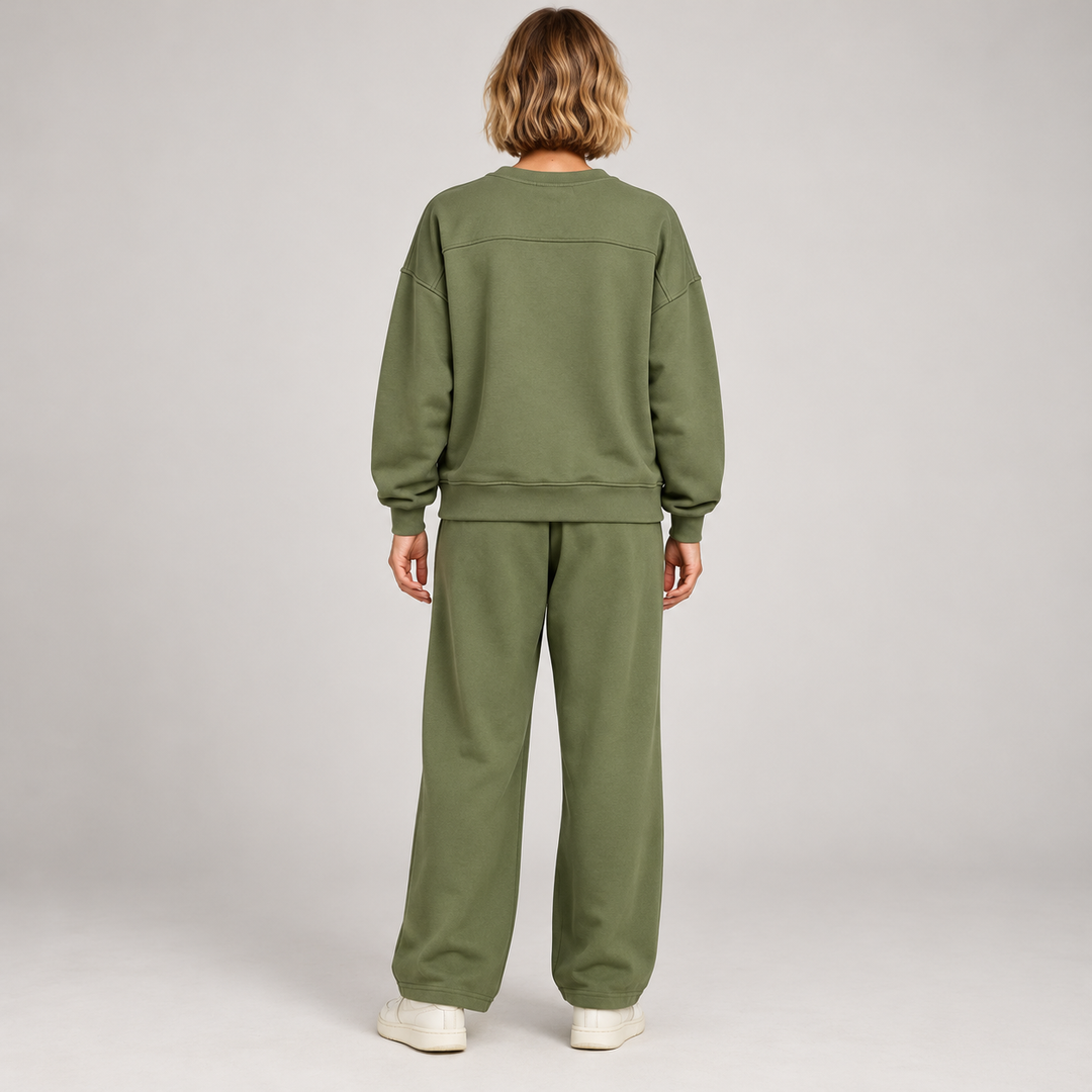Rear view of the green sweatshirt and wide-leg trouser set with a plain back on a full-length model
