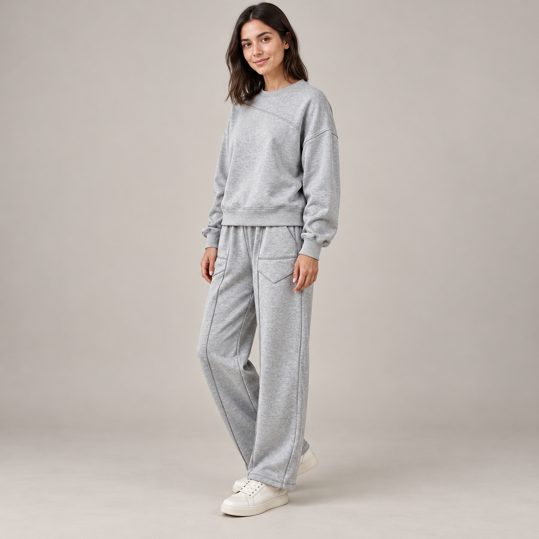 Side and three-quarter view of the gray sweatshirt and wide-leg trouser set on a full-length brunette model