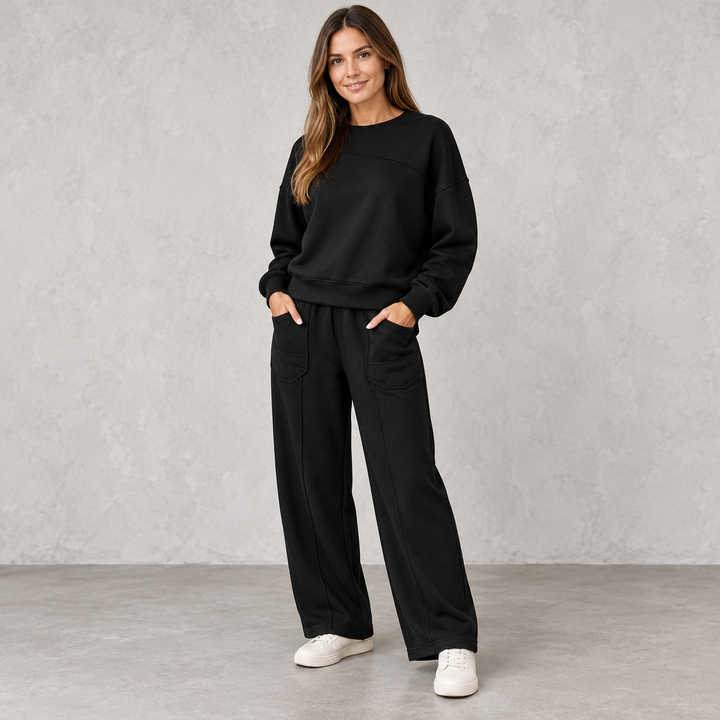 Black sweatshirt and wide-leg trouser set with front patch pockets on a full-length model