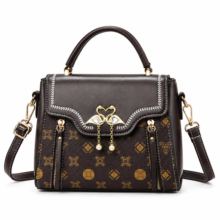 Front of the brown square flap bag with top handle and decorative stitching.