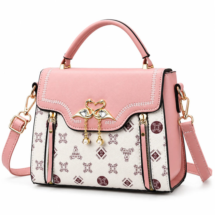 Pink square crossbody bag with patterned front and flap closure on a white background.