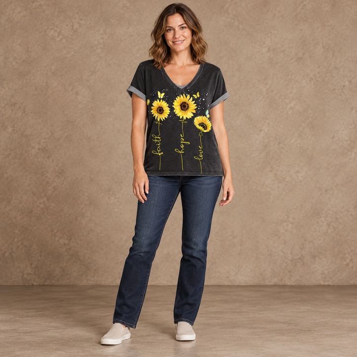 Black sunflower V-neck T-shirt with gray sleeve edges, shown full length on a model in a taupe studio