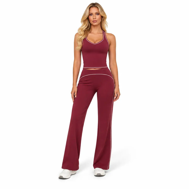 Cherry Red two-piece outfit on a full-body model, showing sleeveless top, light contrast piping and full-length flared pants.