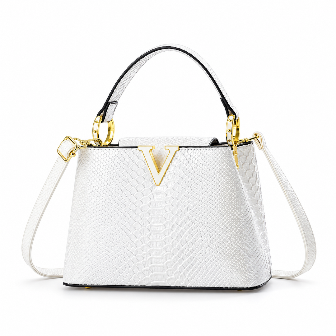White PU handbag in wider front product view showing its top handle, embossed surface and gold-tone ornament on white ground.