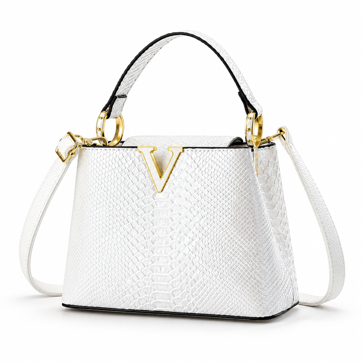 White PU handbag shown in studio front three-quarter view with its embossed finish, top handle gold rings and shoulder strap.