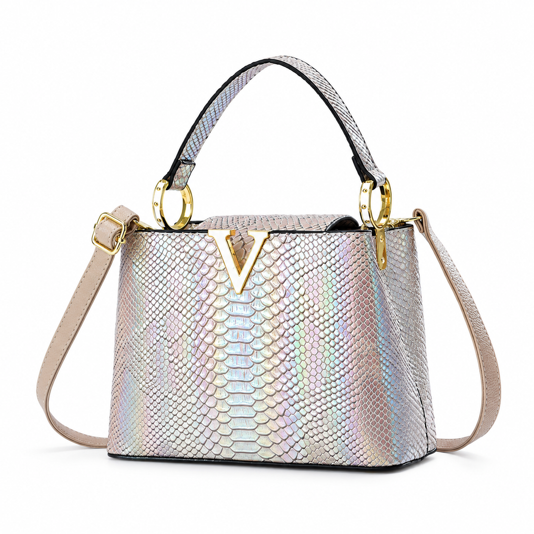 Silver PU handbag showing the iridescent embossed scale finish, top handle, shoulder strap and gold-tone V ornament on white.