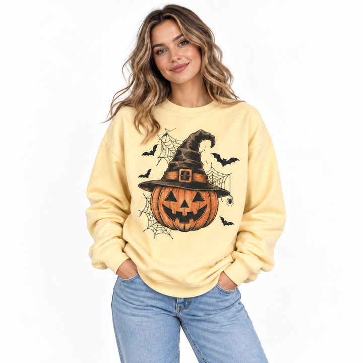 Hero image of pumpkin witch hat sweatshirt on a model with Halloween graphic clearly visible against clean studio background.