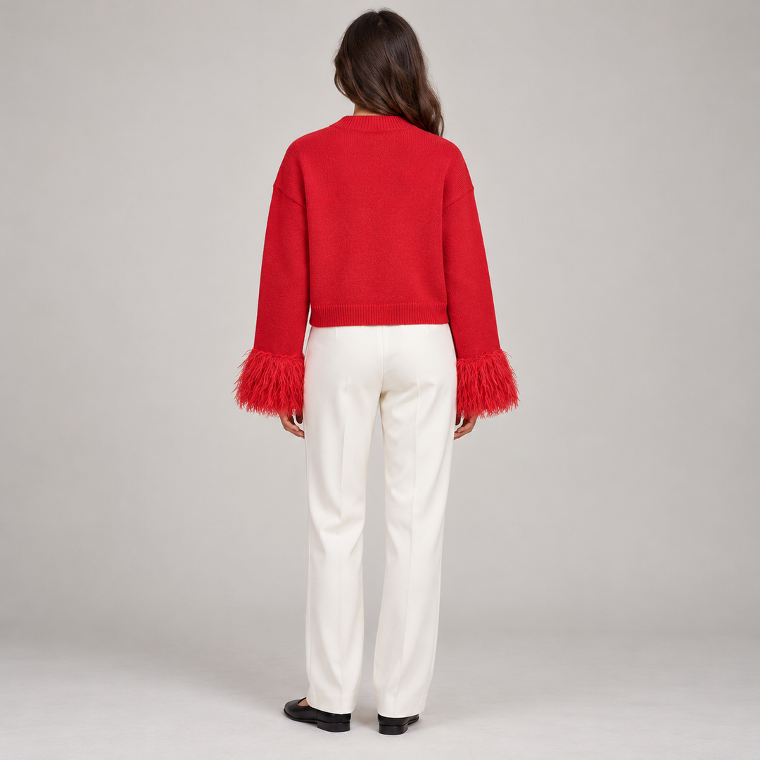 Full-body back view of the red cardigan showing the plain knit back and feather cuffs
