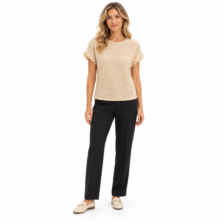 Apricot ruffle sleeve blouse on a full-length model with dark tailored trousers, showing a round neckline and textured finish