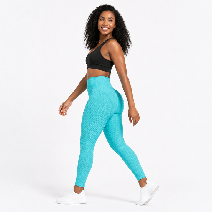 Aqua textured scrunch leggings shown on an adult model in a natural movement pose with a high waist and close active fit.