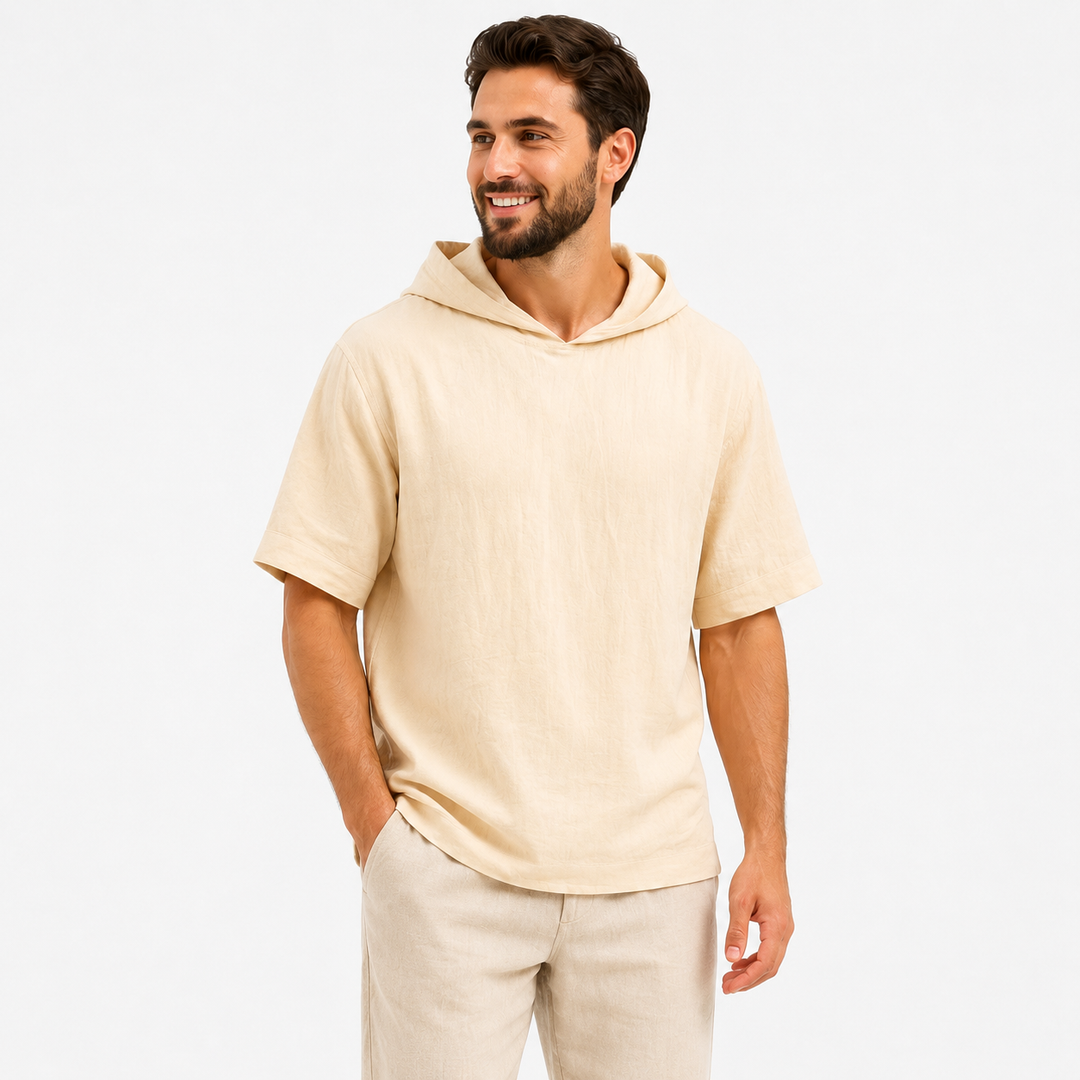 Close view of an apricot short sleeve hoodie showing the hood, sleeve edges, hem, and fabric texture.
