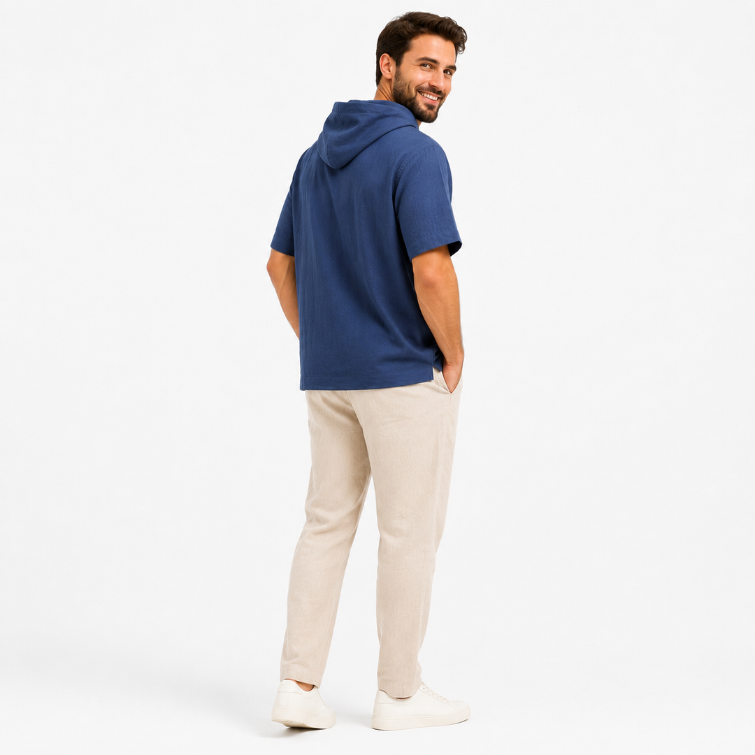 Man wearing a sapphire blue short sleeve hoodie, rear view showing the hood and back length.