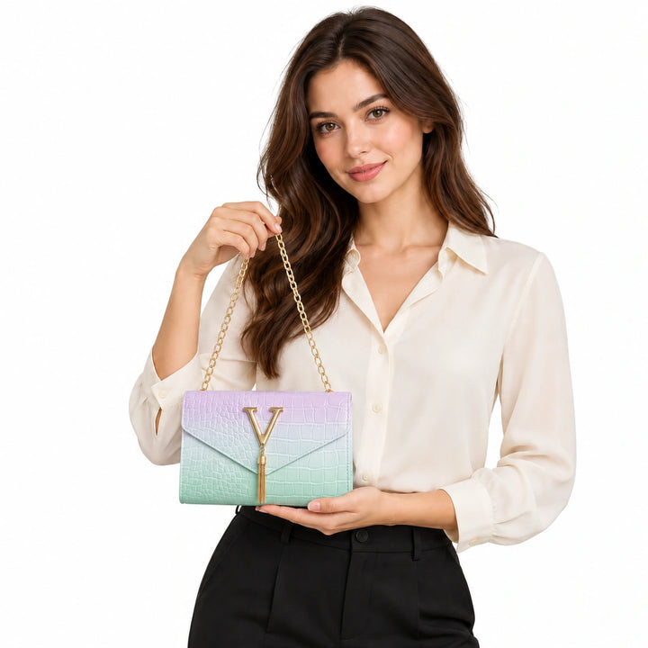 Woman presenting the light green gradient chain shoulder bag with gold V and tassel