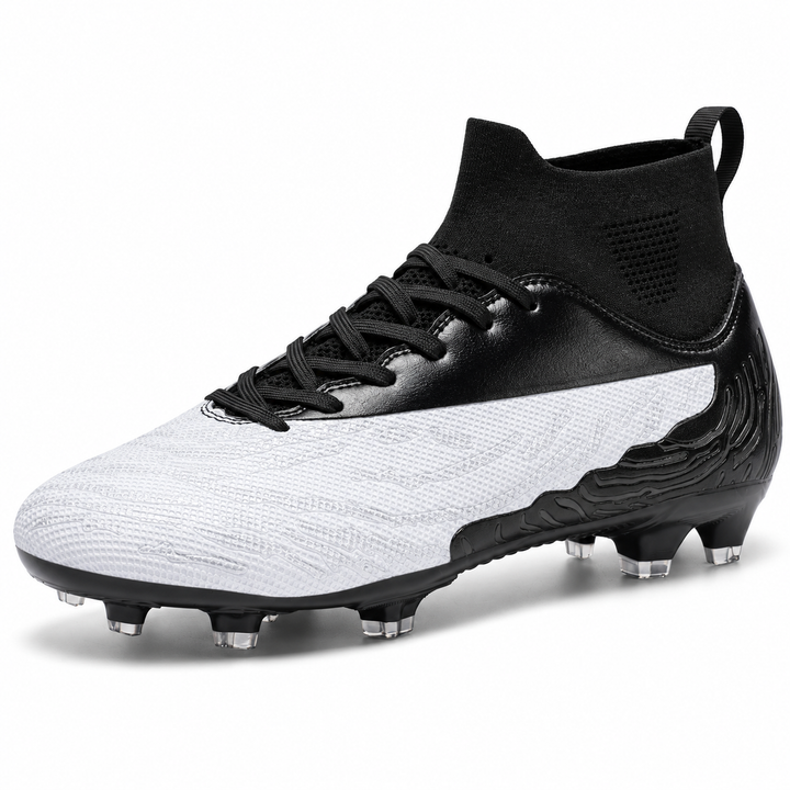 Soccer cleats for sale in white and black, angled studio view showing textured upper, lace closure and molded outdoor studs.