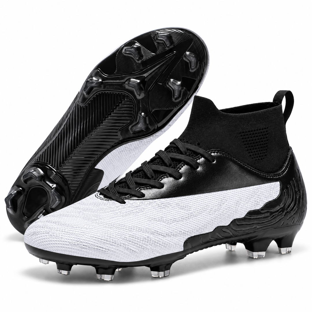 White and black soccer cleats shown as a pair with one outsole visible, highlighting the molded stud layout for outdoor play.