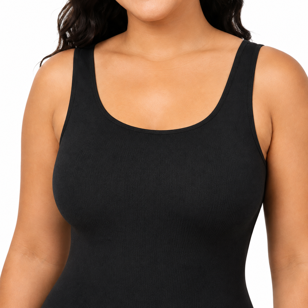 Black shapewear bodysuit close-up showing scoop neckline, wide strap, fabric texture and clean garment finish in studio view.