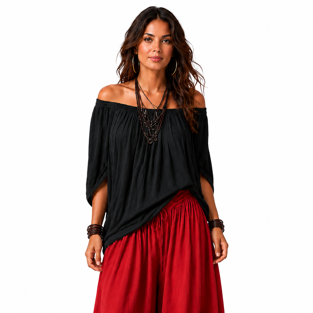 Close view of a black off-shoulder top and red gathered pants showing the neckline, sleeves, waist, and fabric drape.