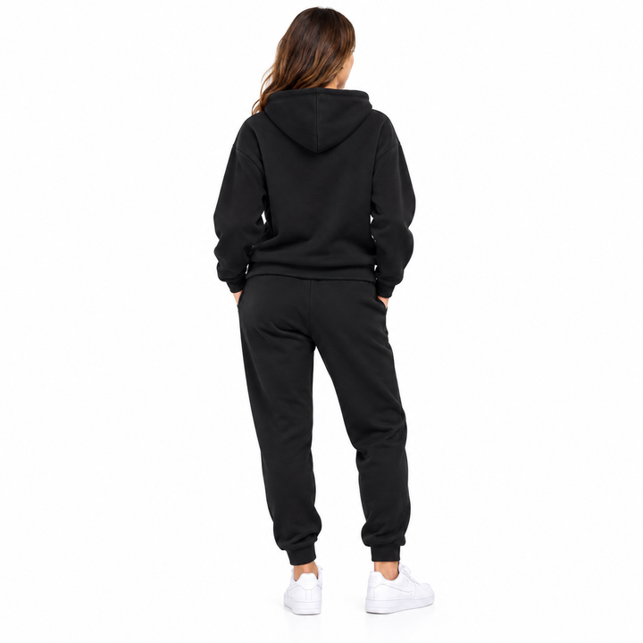 Unisex graphic sweatsuit set in black on a female model, full front view