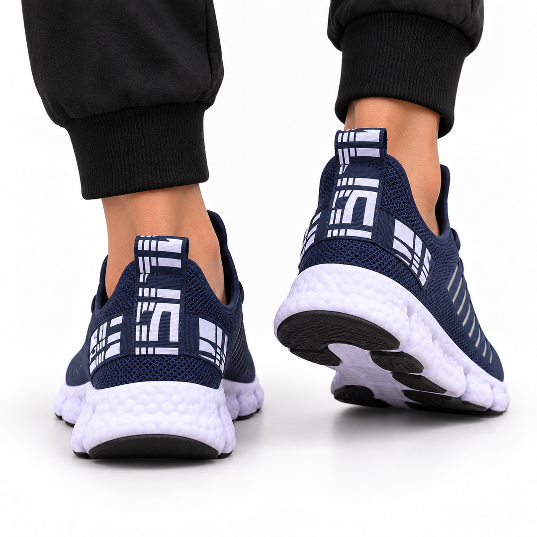 Deep navy casual sneakers shown from the back on a clean studio background with heel tabs and segmented white soles visible.