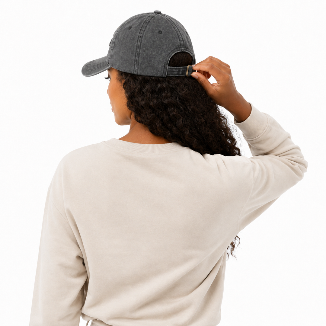 Unisex NYC baseball cap - model adjusting buckle back strap for fit