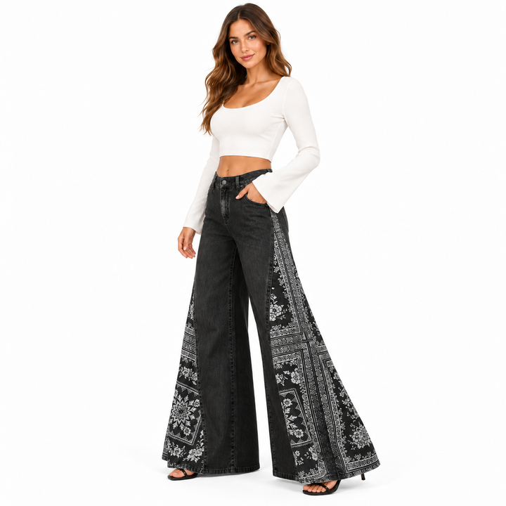 Washed black wide leg pants in a three-quarter studio pose with decorative side print
