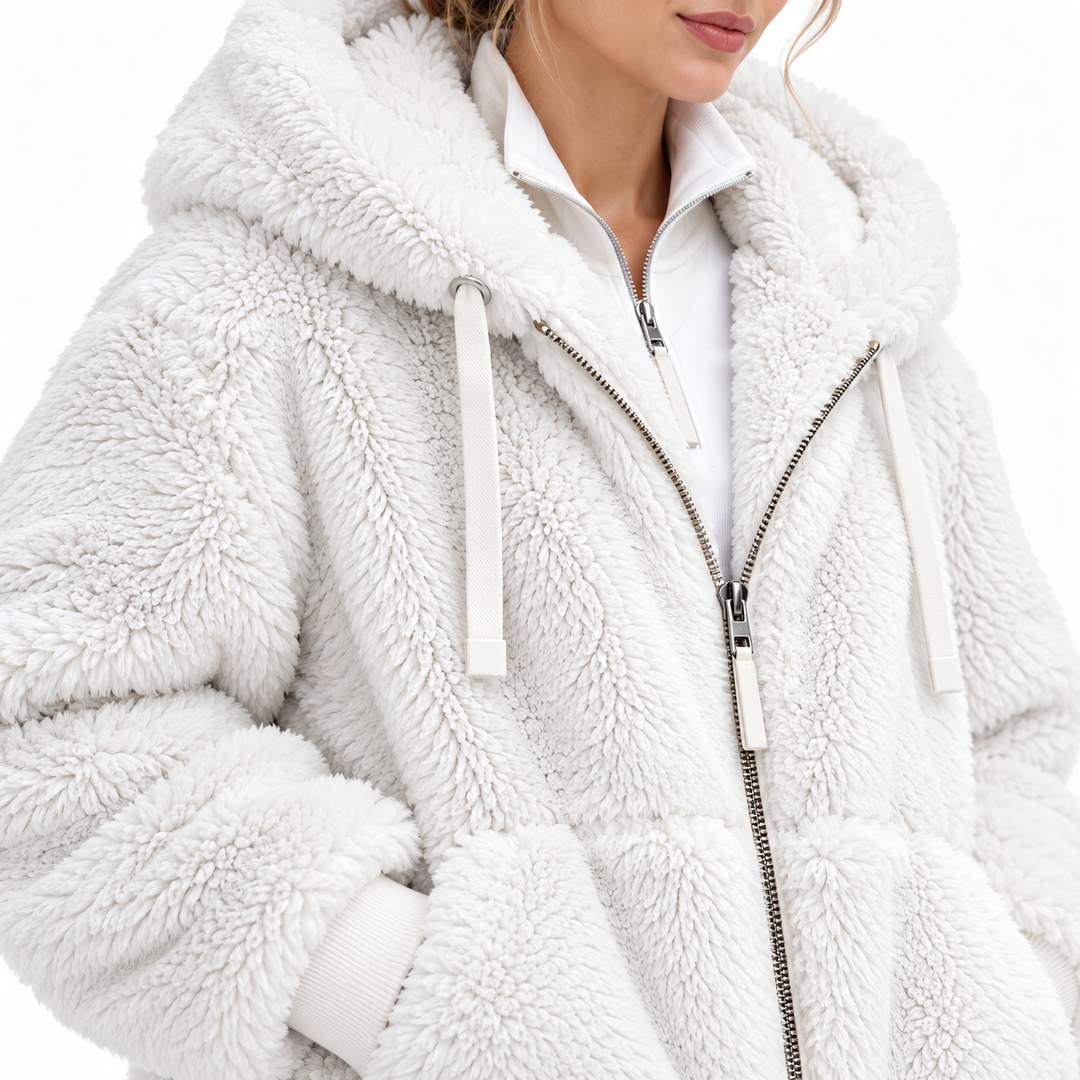White hooded jacket close-up showing textured fleece surface, zipper and drawstrings