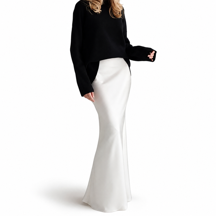 White high-waisted flowy maxi skirt on model, full studio view with smooth waistband, long silhouette and softly flared hem.