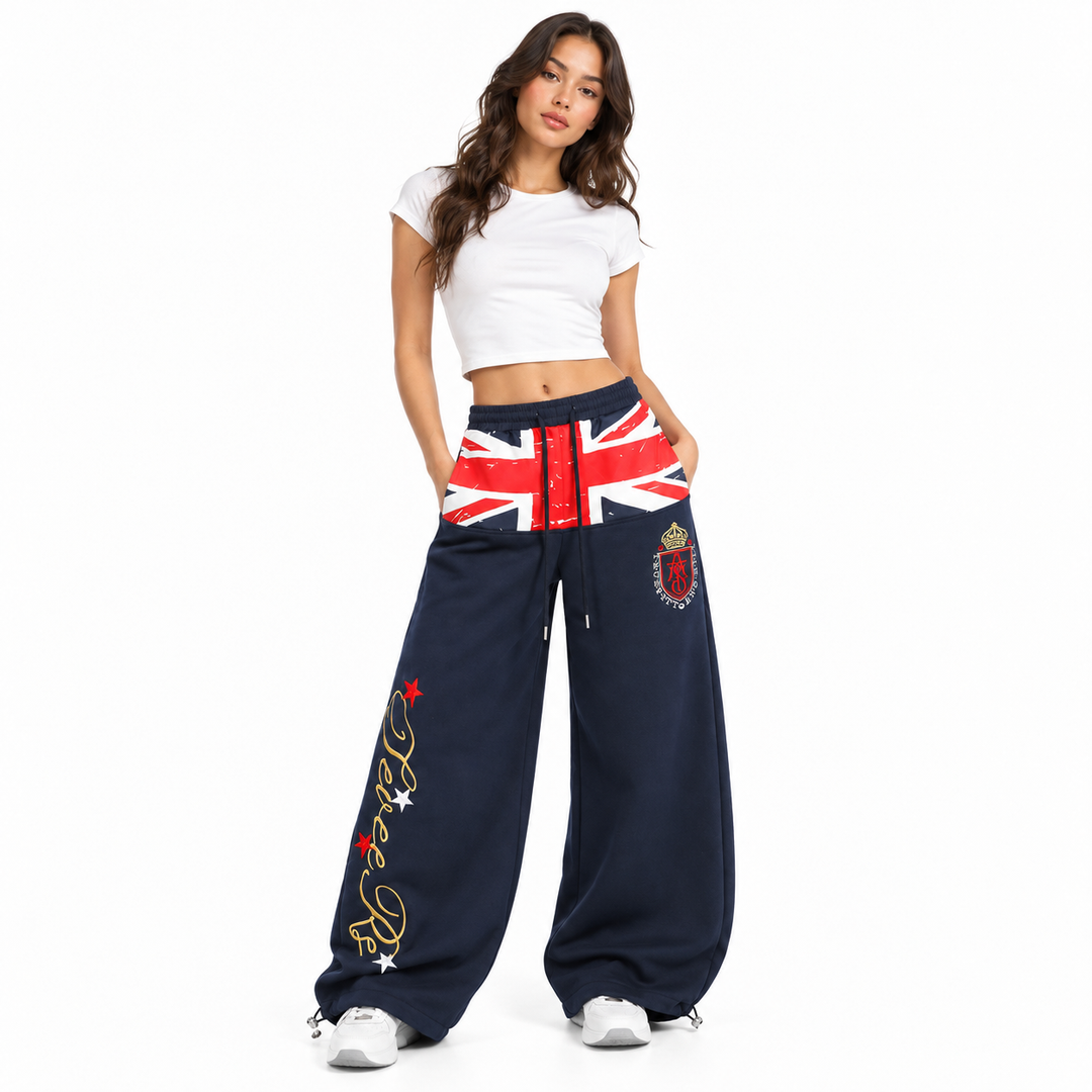 Model wearing navy wide leg sweatpants with flag print on white background