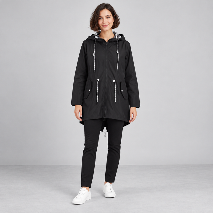Full-body model wearing a black hooded zip-front windbreaker.