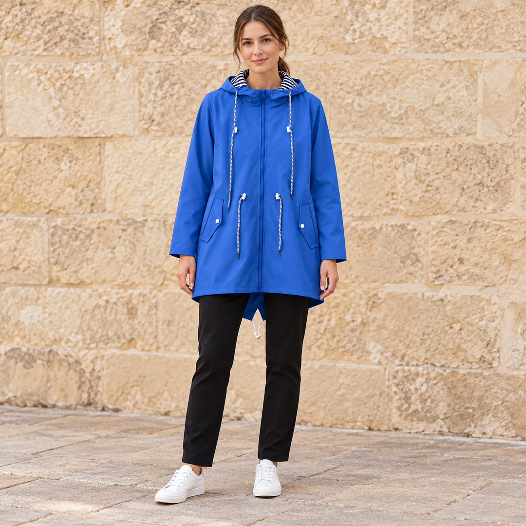 Full-body model wearing a blue hooded zip-front windbreaker.