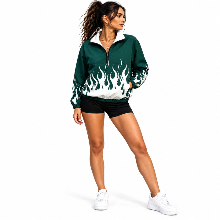 Woman wearing a green and white flame-print pullover jacket with a half zipper, shorts and sneakers in full-body studio view.
