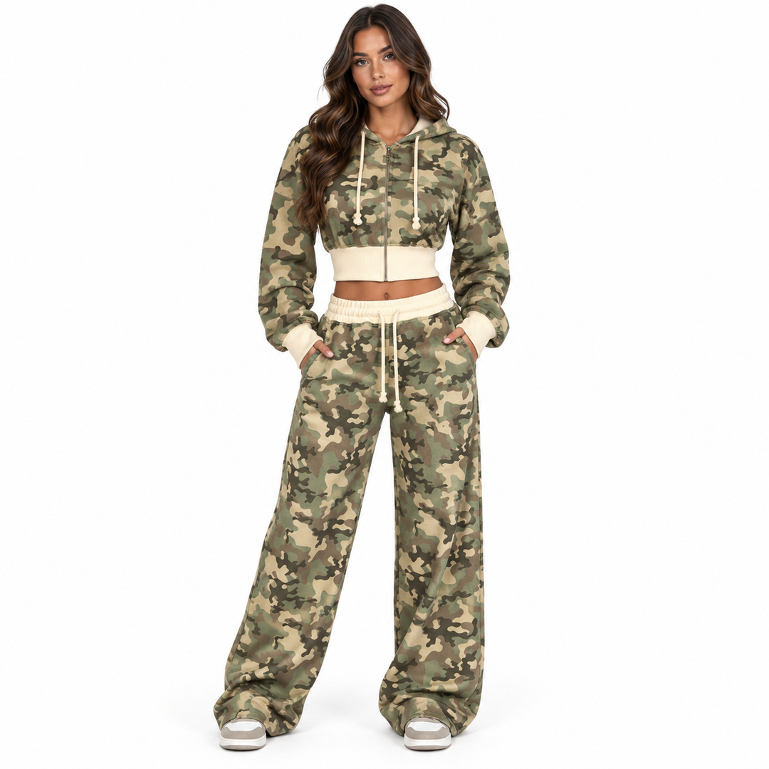 Woman wearing the camouflage crop hoodie and wide-leg sweatpants set in a front studio view on a clean white background.