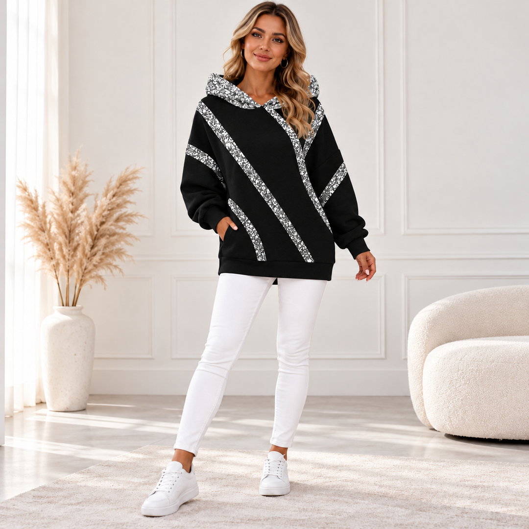 Black sequin hoodie with silver diagonal stripes, front view on model