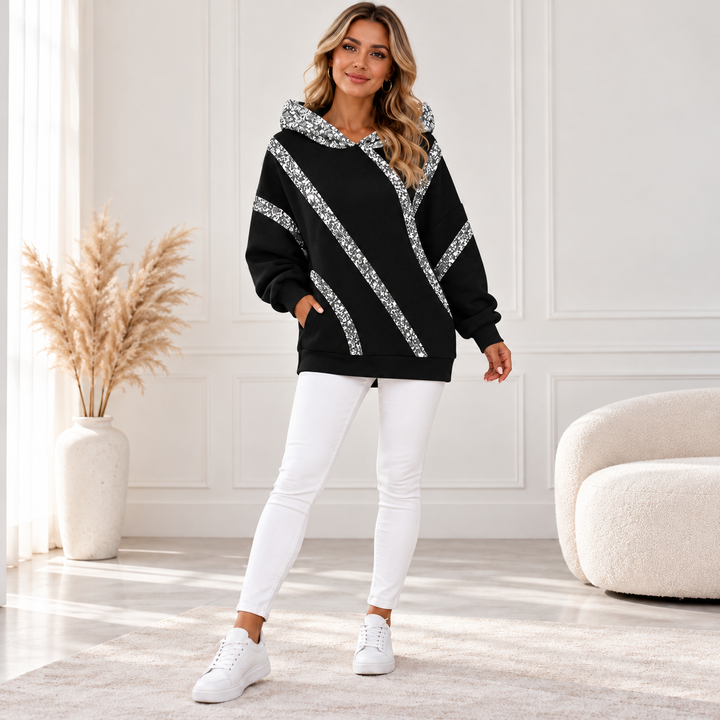 Black sequin hoodie with silver diagonal stripes, front view on model