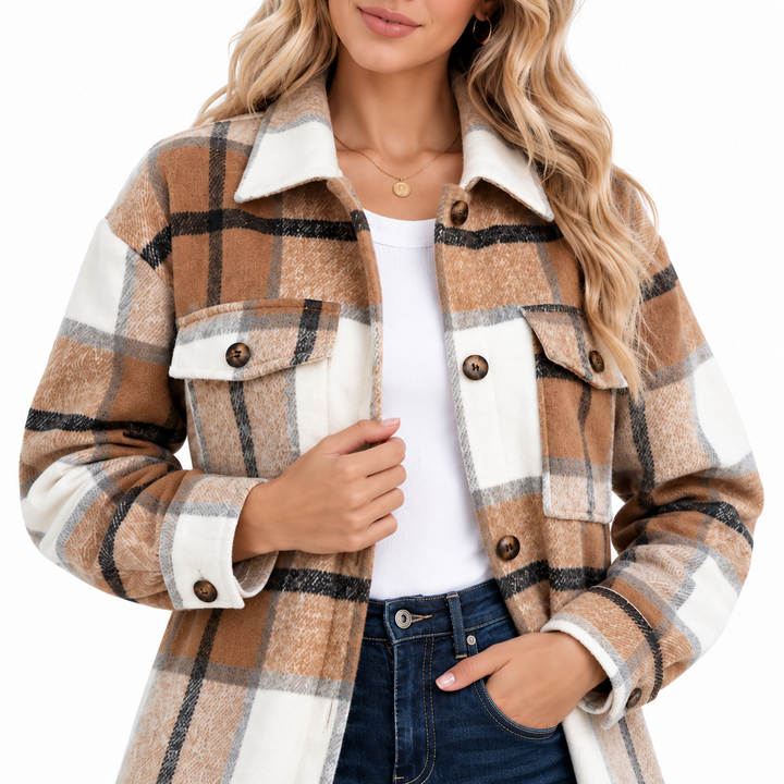 Women shacket close front detail showing collar, chest flap pockets, buttons, plaid pattern and fabric texture on white.