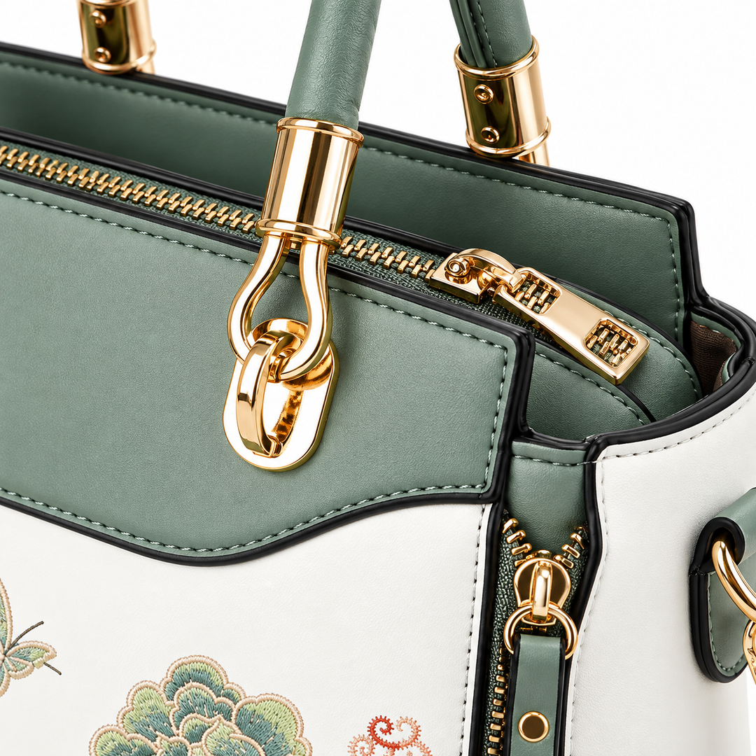 Close-up of shoulder bag gold-tone hardware, zipper, stitching and Sage Green trim