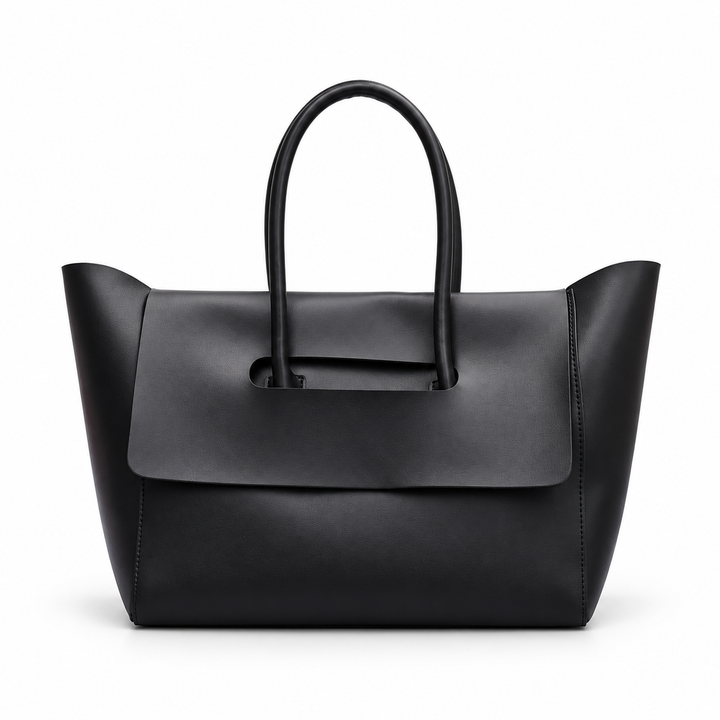 Women shoulder bag in Black with double rounded handles and a broad front flap, photographed on a pure white studio backdrop.