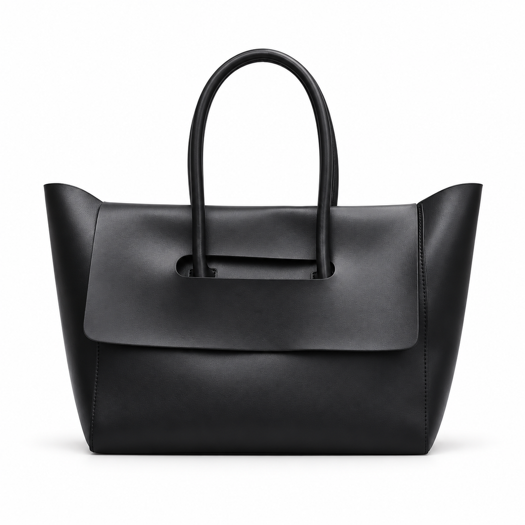 Women shoulder bag in Black shown from the front, with double handles, flared sides and the wide folded flap clearly visible.