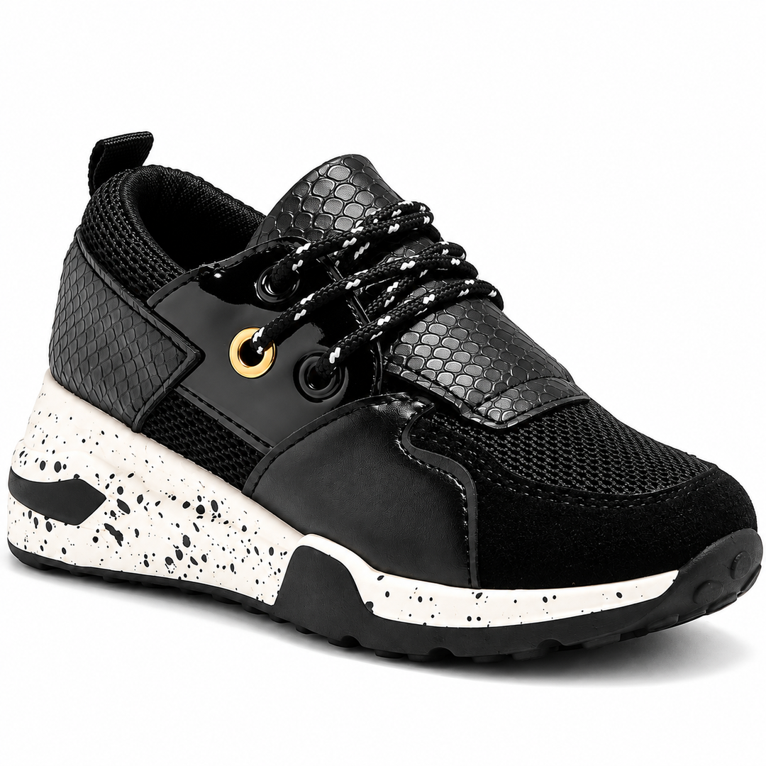 Black sneaker close-up showing eyelets and textured upper