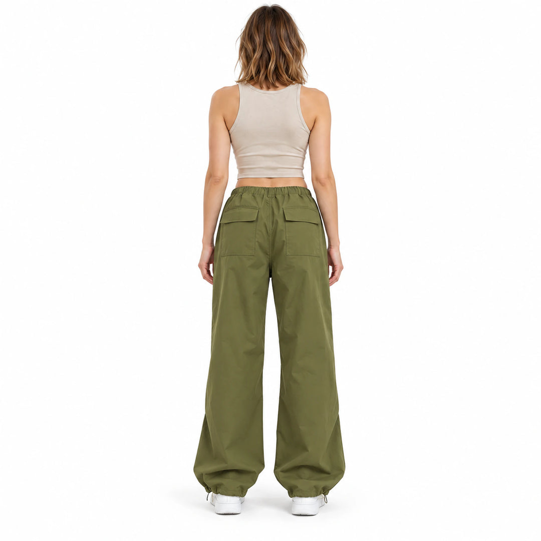 Back view of the army green cargo pants on a model, showing both flap pockets at the rear and a roomy full-length silhouette.
